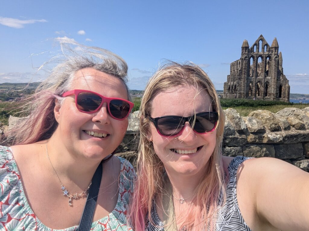Chris and Meg away in Whitby in front of the abbey